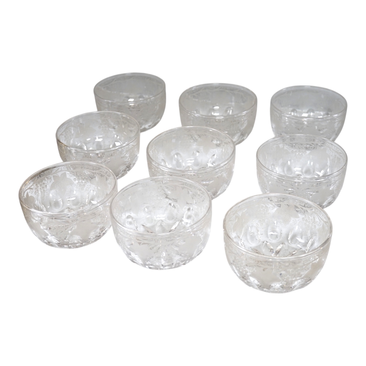 Nine vine engraved glass finger bowls, 13cm diameter. Condition - good.